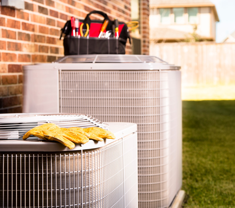 2 AC units with a technicians tools on them